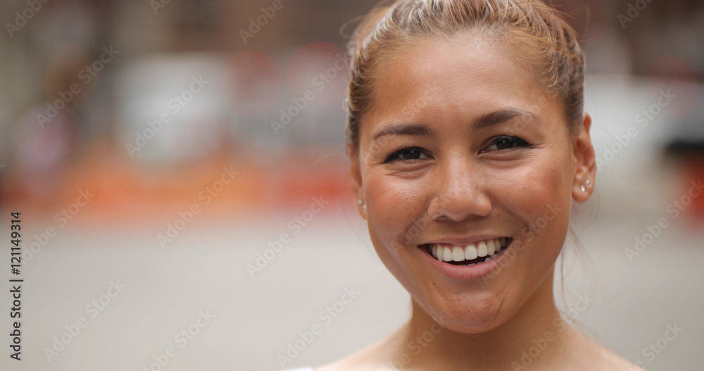 Young Latina woman in city face portrait happy smile Young Latina woman in city face portrait happy smile