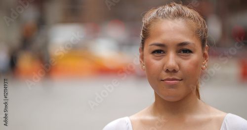 Young Latina woman in city face portrait photo