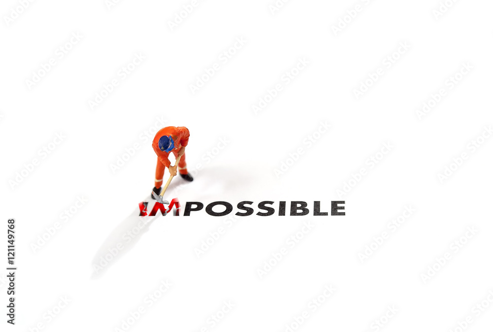 Worker digging with the text impossible, digging the word im so it written possible. success and challenge concept. Worker digging with the text impossible, digging the word im so it written possible. success and challenge concept.