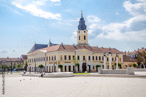 10 September 2016 - Oradea, Romania: Unirii Square with the Kovats House built in classicist architectural style and the tower from the Greek Catholic Christian Baroque Church