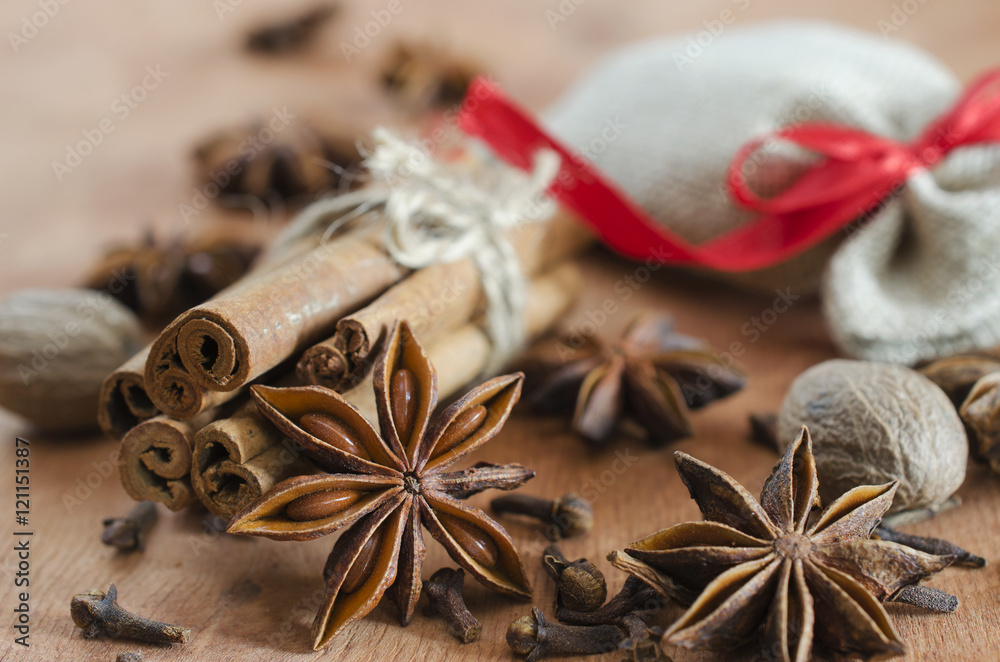 Spices for mulled wine. Cinnamon sticks, anise stars and cloves on wooden background. Spices for mulled wine. Cinnamon sticks, anise stars and cloves on wooden background.