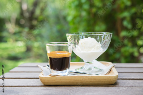 Affogato coffee on wooden table in the garden, background concep