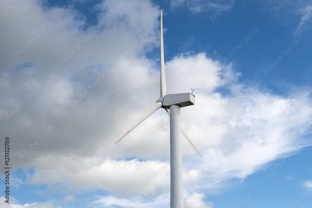 Wind mill against blue sky with clouds for energy production Wind mill against blue sky with clouds for energy production