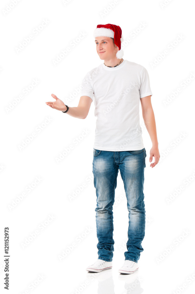 Caucasian boy wearing christmas hat for santa. Teenager in white t-shirt. Portrait of a happy young man wearing Santa Claus hat. Caucasian boy wearing christmas hat for santa. Teenager in white t-shirt. Portrait of a happy young man wearing Santa Claus hat.