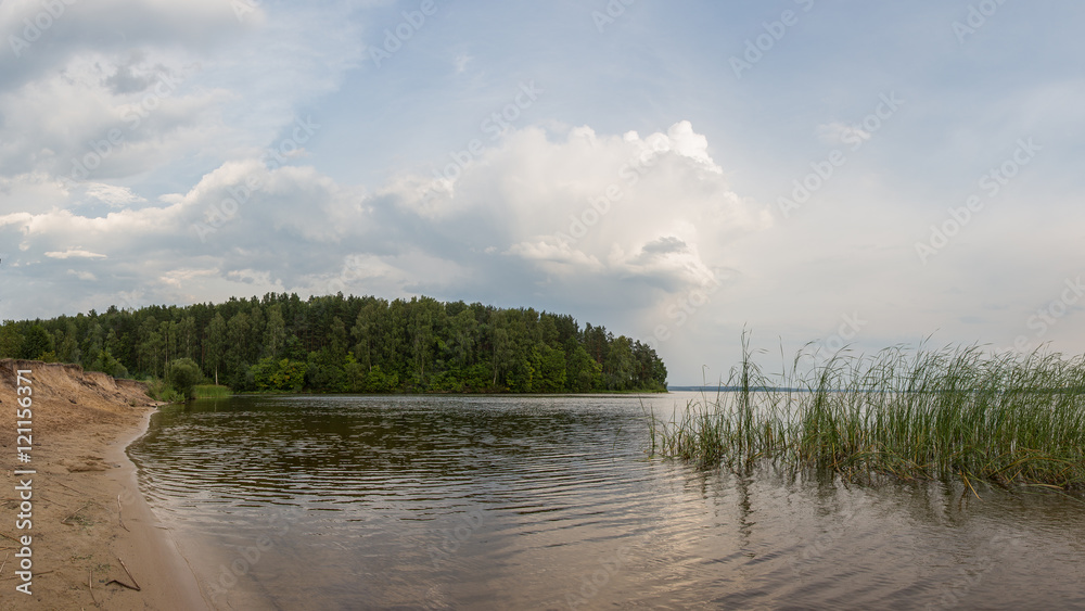 A panoramic view of the lake after a summer storm. Summer evening by Sura reservoir, Russia.