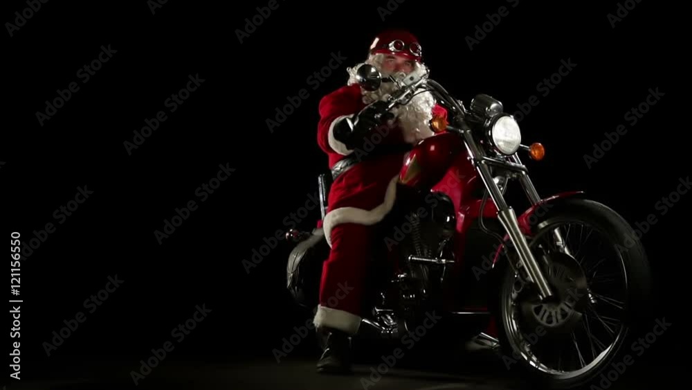 Santa Claus portrait on his red motorbike prepares for Christmas gift delivery Santa Claus portrait on his red motorbike prepares for Christmas gift delivery