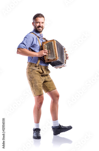 Man in traditional bavarian clothes playing accordion. Oktoberfe photo
