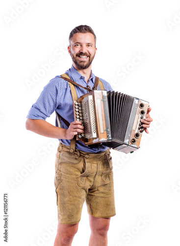 Man in traditional bavarian clothes playing accordion. Oktoberfe