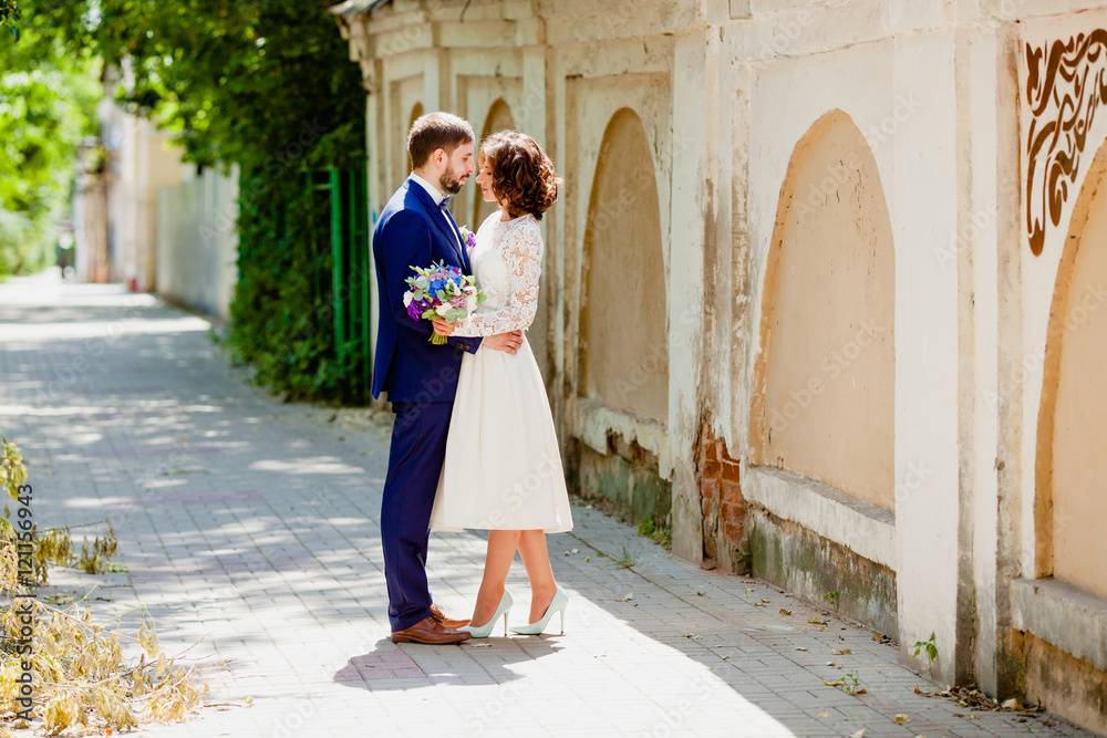 The bride and groom on the sunny street