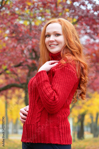 girl portrait in autumn season, background from red and yellow leaves