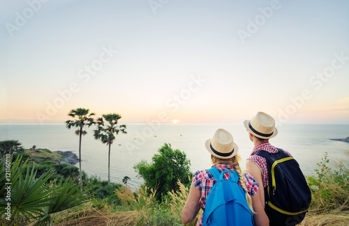 Traveling and trekking concept. Young loving couple  walking on mountains near the sea. © luengo_ua