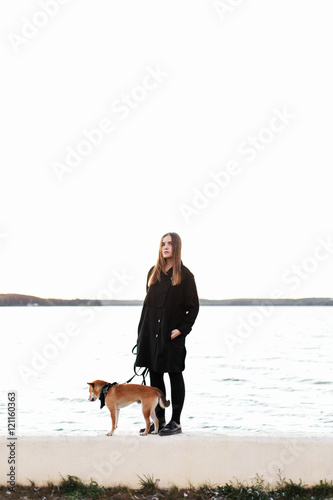 Girl standing with japan dog