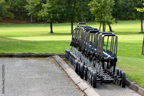 Golf trolleys waiting for golfers.