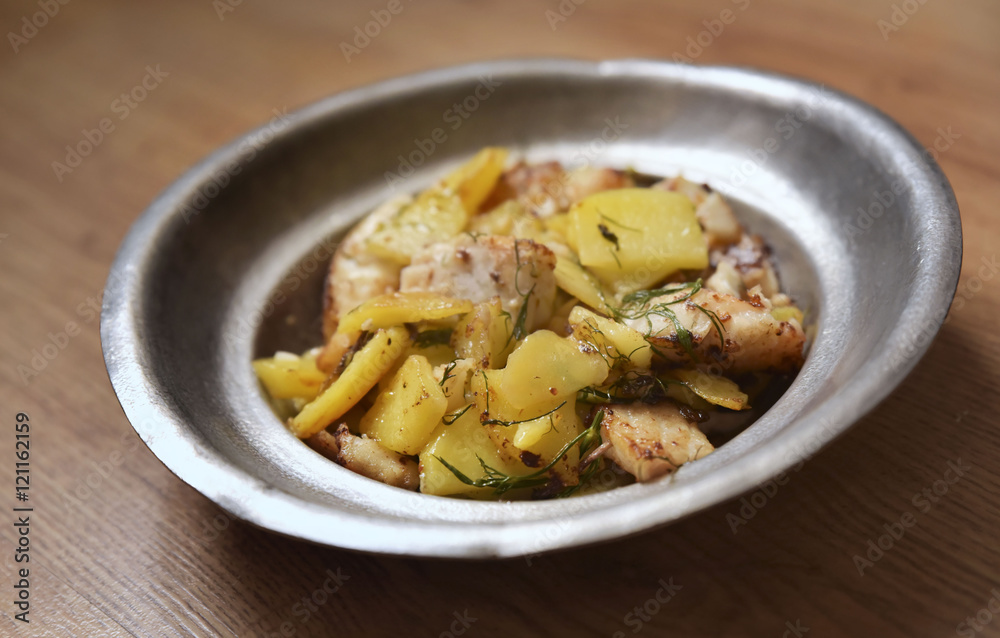 Zander fillet served with fresh potatoes on old plate Zander fillet served with fresh potatoes on old plate