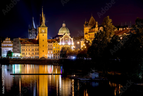 Scenic night view of Charles Bridge and buildings along the Vltava river. Prague, Czech Republic