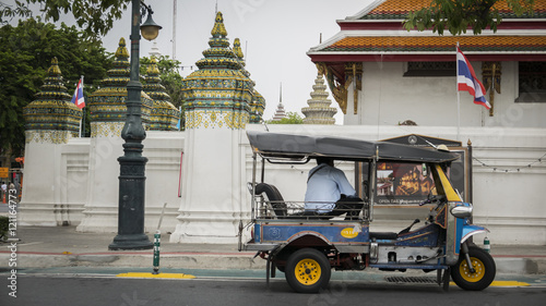  Tuk Tuk taxi waiting customers on street at Wat Phra Chetupon Vimolmangklararm (Wat Pho) temple in Thailand.