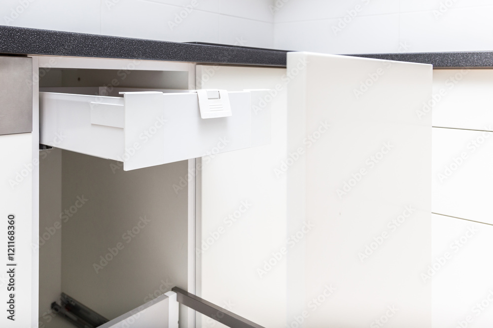 Opened kitchen drawer with high front for garbage bin and inner drawer inside for sundries and other small objects Opened kitchen drawer with high front for garbage bin and inner drawer inside for sundries and other small objects