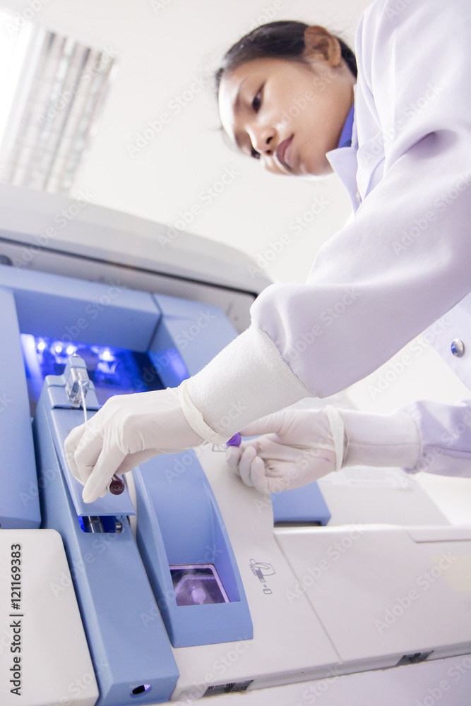 doctor testing blood with Hematology analyzer machine doctor testing blood with Hematology analyzer machine