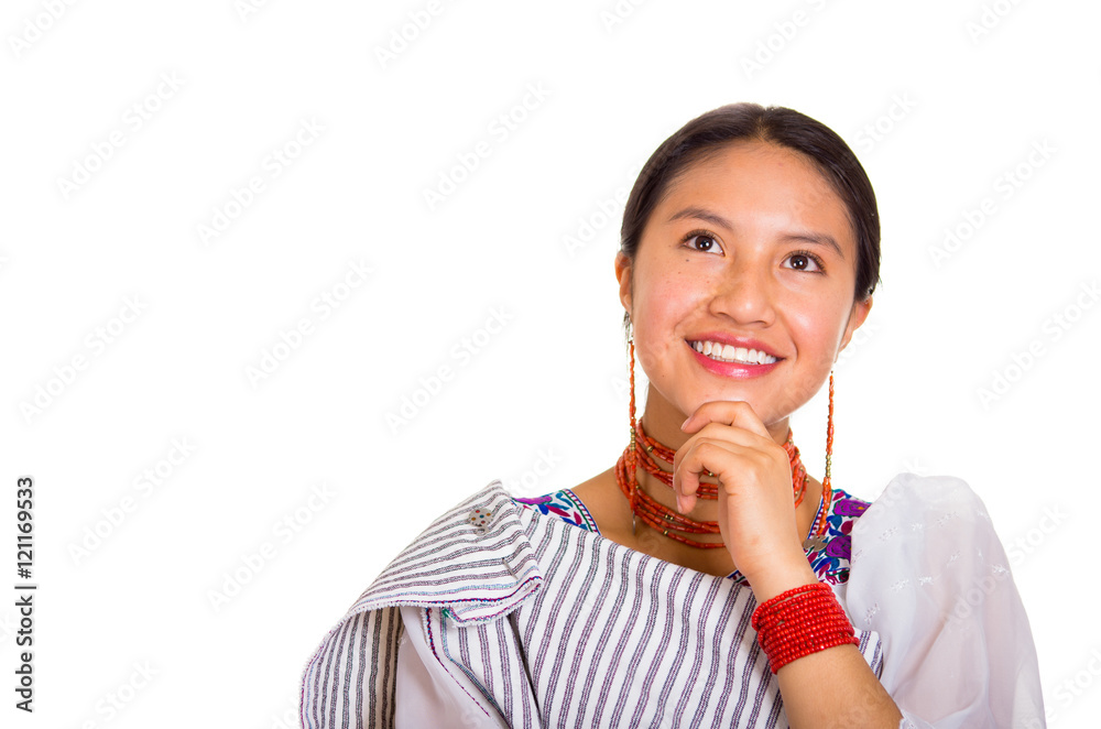 Headshot beautiful young woman wearing traditional andean shawl and red necklace, posing for camera using hands touching head interacting, white studio background Headshot beautiful young woman wearing traditional andean shawl and red necklace, posing for camera using hands touching head interacting, white studio background