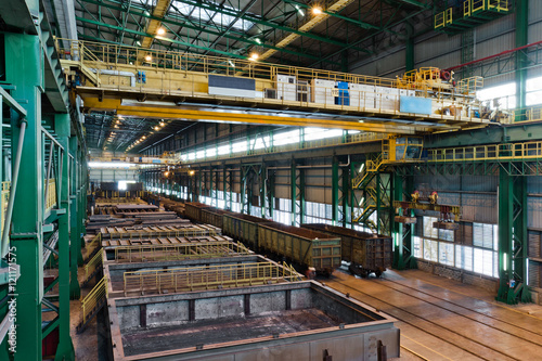 Metallurgical plant warehouse with crane and railway tracks