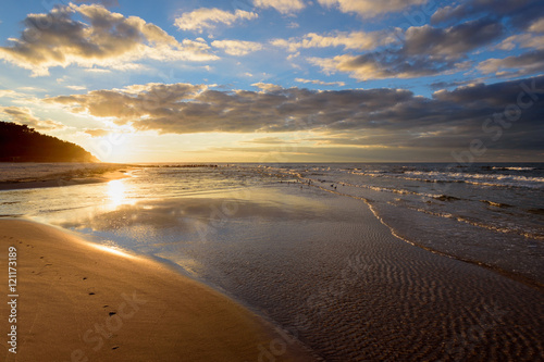 Beautiful sandy Debki beach with waves at sunset time.  Baltic Sea  Poland. 