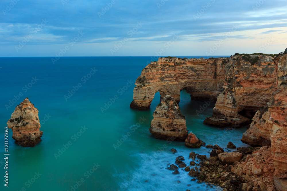 Evening Atlantic rocky coastline near Lagoa, in Algarve, Portuga