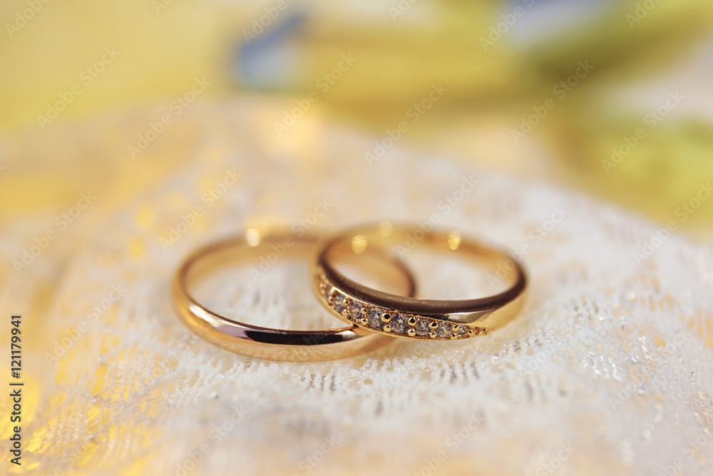 Beautiful wedding rings on white fabric background Beautiful wedding rings on white fabric background