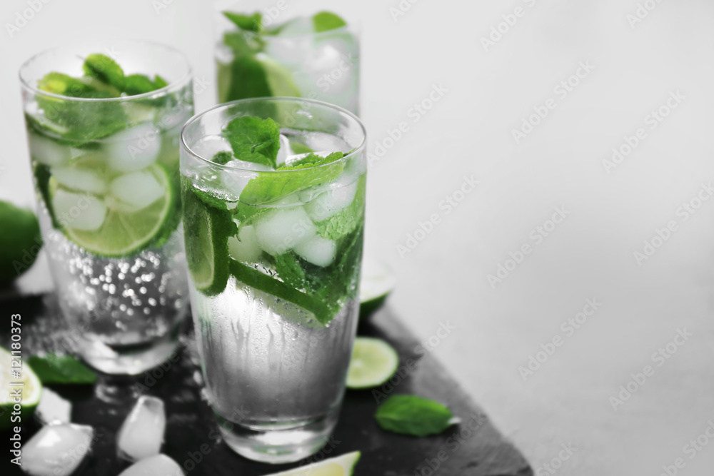 Cold fresh cocktails with lime on slate plate Cold fresh cocktails with lime on slate plate