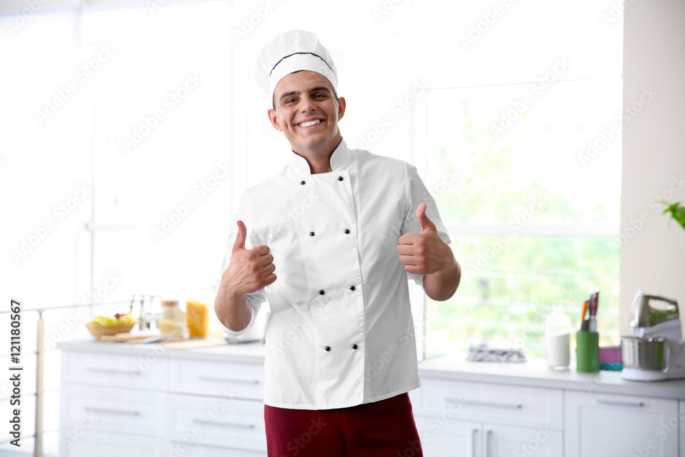 Young handsome chef cook in kitchen