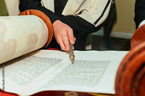 Hand of boy reading the Jewish Torah at Bar Mitzvah 5 SEPTEMBER 2016 USA