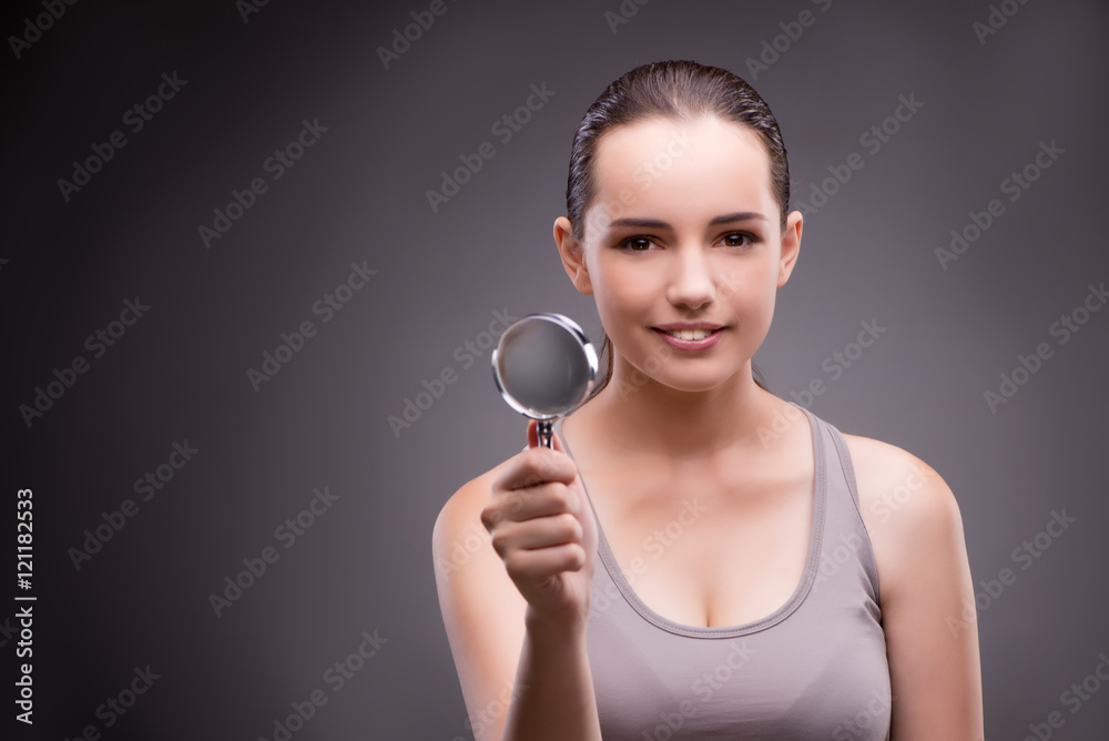 Woman with magnifying glass in sports concept Woman with magnifying glass in sports concept