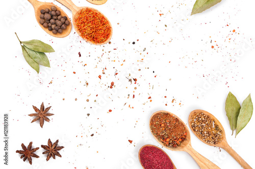 Fototapeta Naklejka Na Ścianę i Meble -  Different spices in spoons on white background