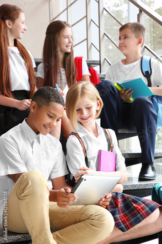 Schoolchildren sitting on s...
