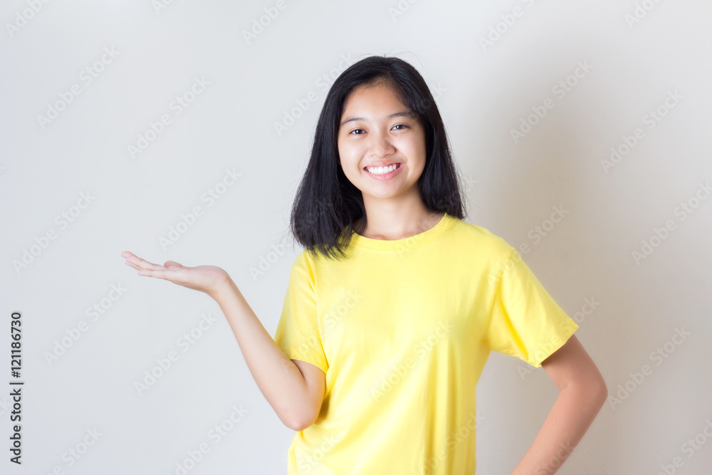 Woman showing your product or message smiling happy on white wal Woman showing your product or message smiling happy on white wal
