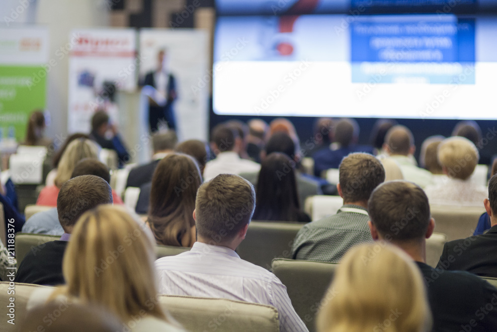 Business Concepts. People At the Conference Listening to Speaker Presenting on Stage