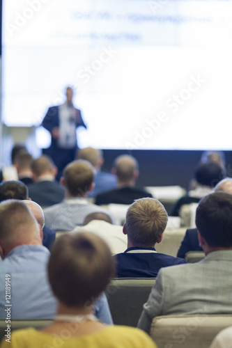 Business Ideas and Concepts. People at the Business Conference Listening to the Host on Stage