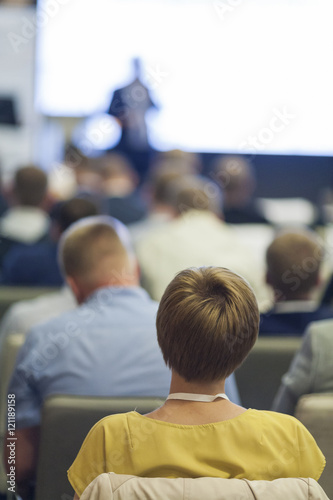 People at the Business Conference Listening to the Speaker Standing in Front of Big Screen