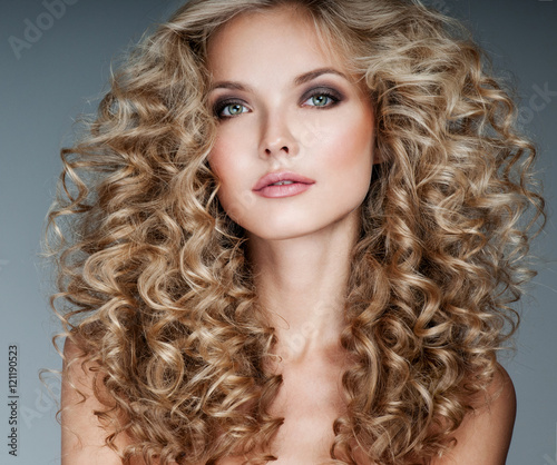 Beautiful blonde woman. Healthy Long Blond Hair. Curly Hair. B