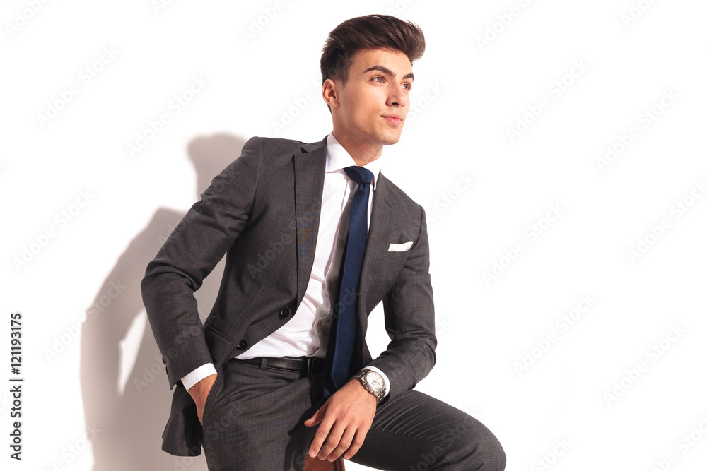 side view of a business man sitting and looking away side view of a business man sitting and looking away