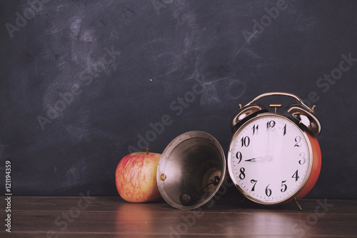 Bell, alarm clock and bell against a blackboard Vintage Retro Fi