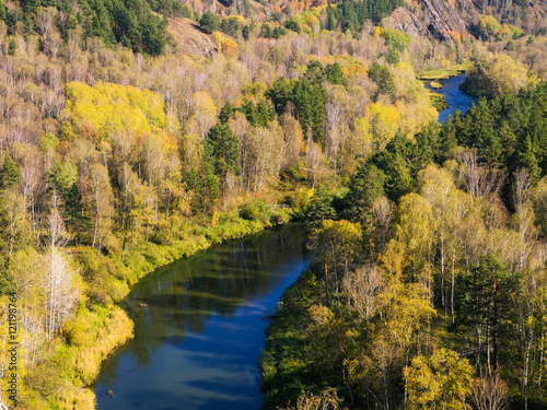 Autumn forest in the valley of the river in the mountains