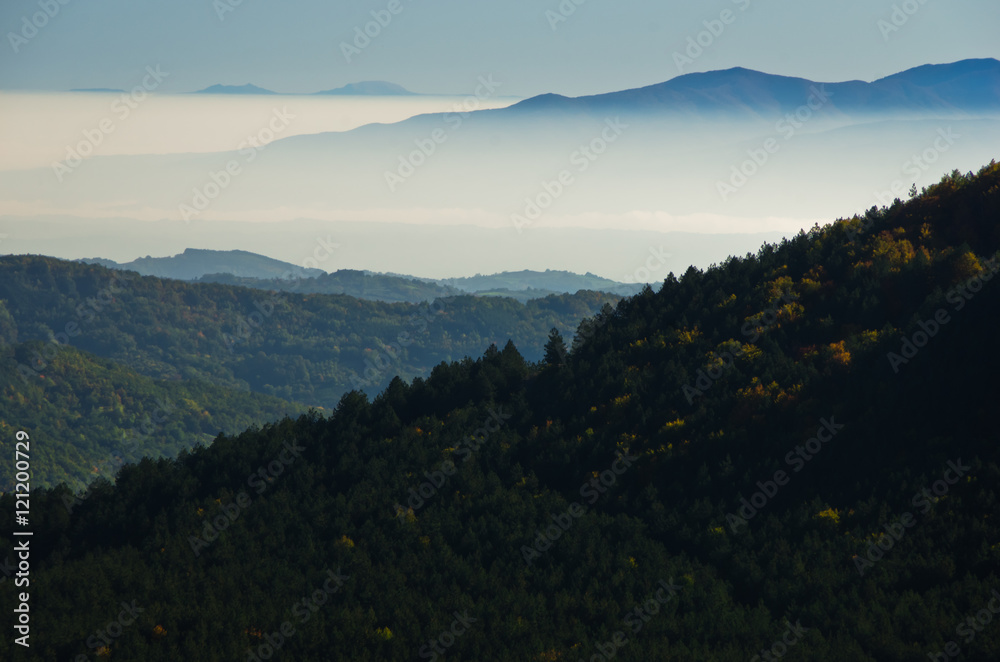 Autumn fog is rolling between hills of Zeljin mountain, Serbia