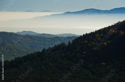 Autumn fog is rolling between hills of Zeljin mountain, Serbia