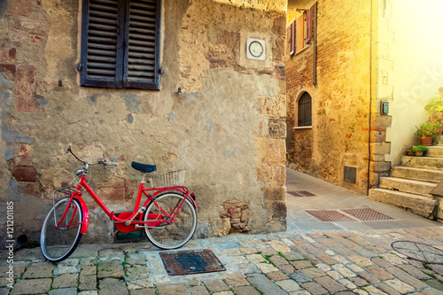 Fototapeta Naklejka Na Ścianę i Meble -  Old Mediterranean town street with red retro bike
