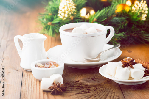 Mug filled Hot chocolate and Marshmallows on old wooden background. Christmas time, selective focus. Holiday concept, toned
