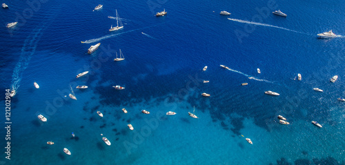 Panorama of sea with multiple yachts near Capri Island, Italy