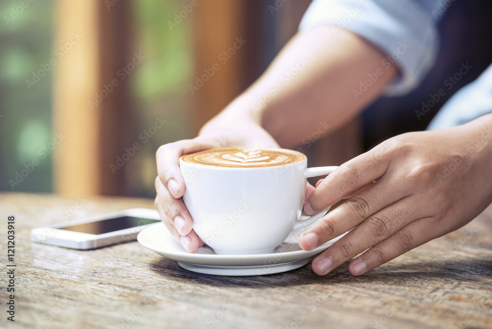 woman holding hot cup of coffee, with heart shape woman holding hot cup of coffee, with heart shape