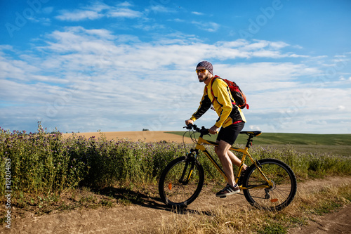 Cyclist Riding the Bike on the Trail
