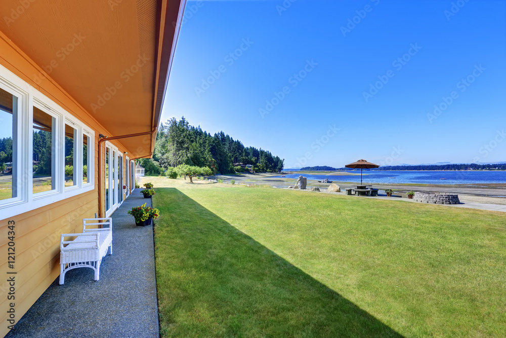 Back yard with stone patio table set and water view Back yard with stone patio table set and water view