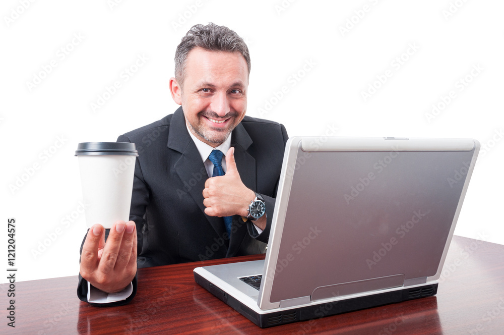 Business man at office holding coffe showing thumb up Business man at office holding coffe showing thumb up